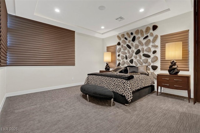 bedroom featuring a tray ceiling and carpet