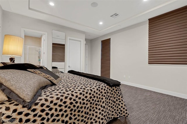 carpeted bedroom featuring a raised ceiling