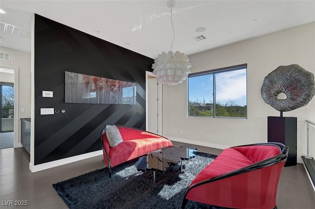 sitting room with an inviting chandelier and a wealth of natural light