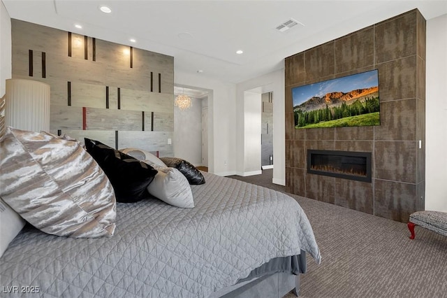 carpeted bedroom with a tile fireplace