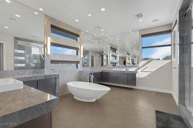 bathroom featuring vanity, separate shower and tub, and a wealth of natural light