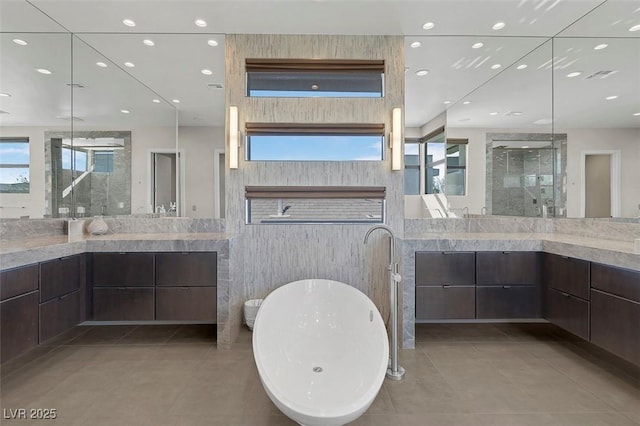 bathroom with a healthy amount of sunlight, vanity, shower with separate bathtub, and tile patterned flooring