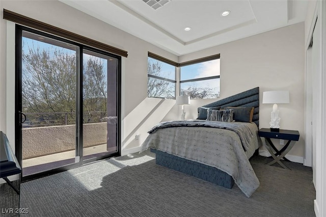 bedroom featuring a tray ceiling and carpet