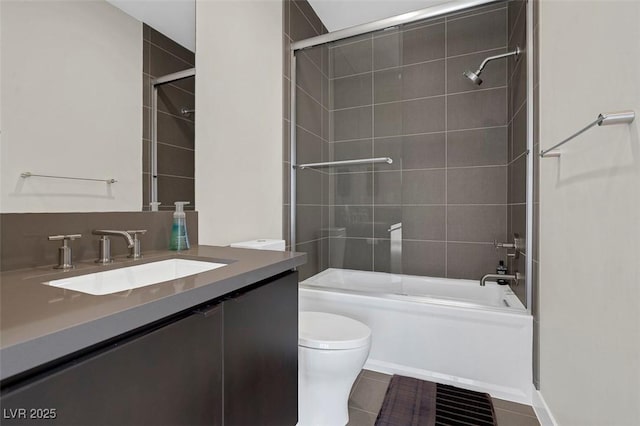 full bathroom with tile patterned floors, vanity, toilet, and combined bath / shower with glass door