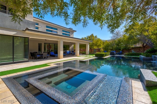 view of pool with an outdoor living space, a patio area, and an in ground hot tub