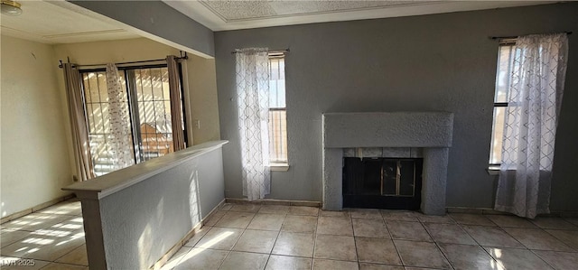 unfurnished living room featuring tile patterned flooring and a healthy amount of sunlight