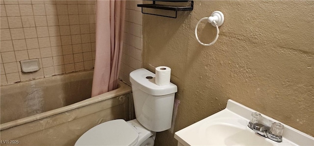 full bathroom featuring shower / bath combination with curtain, toilet, and sink