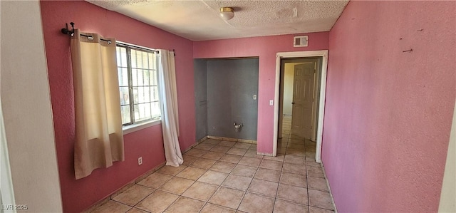 interior space with a textured ceiling