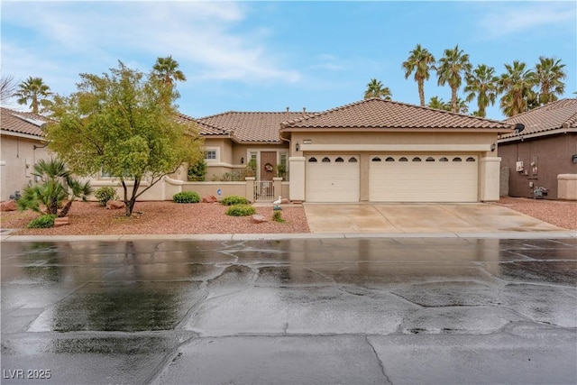 mediterranean / spanish-style home with a garage