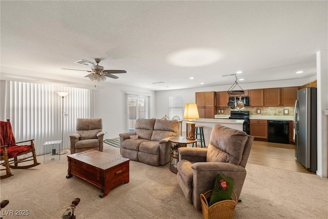 3924 E Garfield Dr, Pahrump, NV 89061 - living room featuring recessed lighting, visible vents, light colored carpet, and a ceiling fan