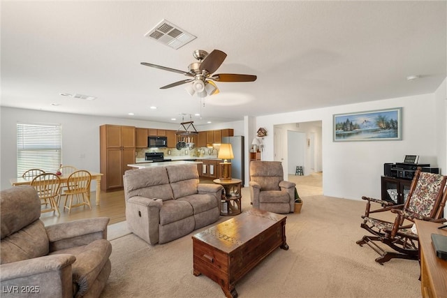 3924 E Garfield Dr, Pahrump, NV 89061 - living area featuring visible vents, recessed lighting, light colored carpet, and ceiling fan