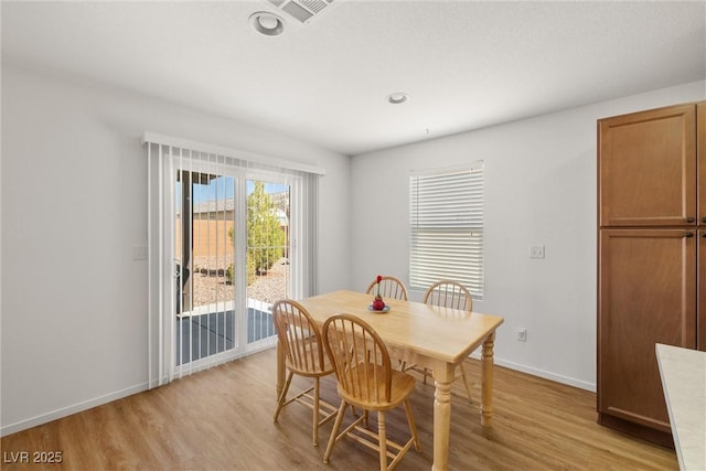3924 E Garfield Dr, Pahrump, NV 89061 - dining room featuring visible vents, baseboards, and light wood finished floors