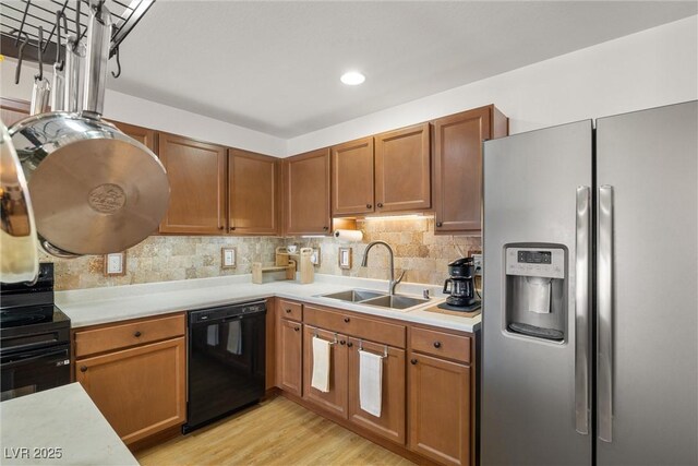 3924 E Garfield Dr, Pahrump, NV 89061 - kitchen featuring backsplash, black appliances, light countertops, and a sink