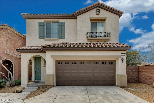 mediterranean / spanish home featuring driveway, an attached garage, and stucco siding