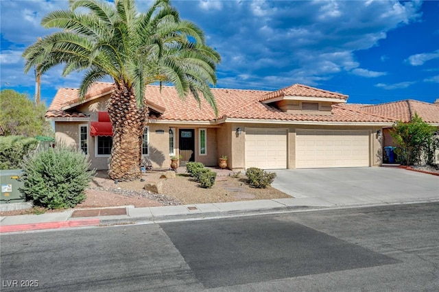 mediterranean / spanish-style house with a garage