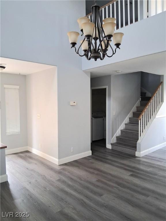 5830 Springmist St, North Las Vegas, NV 89031 - unfurnished living room featuring stairs, baseboards, wood finished floors, and a towering ceiling