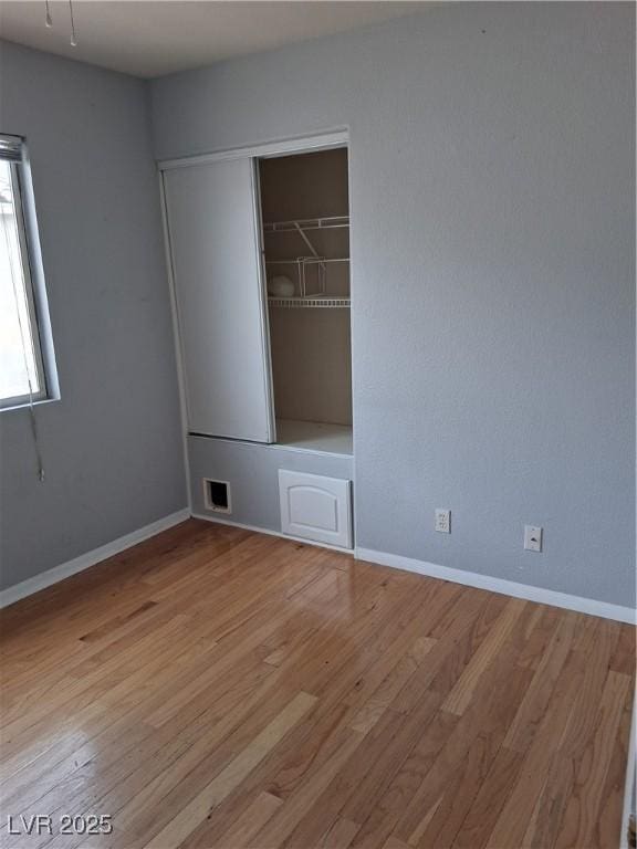 5830 Springmist St, North Las Vegas, NV 89031 - unfurnished room featuring wood finished floors and baseboards