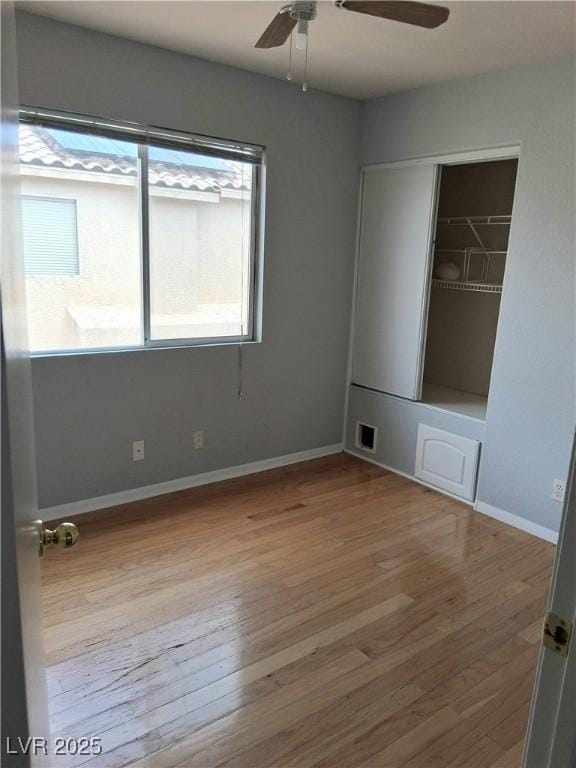 5830 Springmist St, North Las Vegas, NV 89031 - spare room with wood finished floors, a ceiling fan, and baseboards