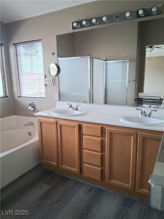 5830 Springmist St, North Las Vegas, NV 89031 - full bath with wood finished floors, a bath, double vanity, and a stall shower