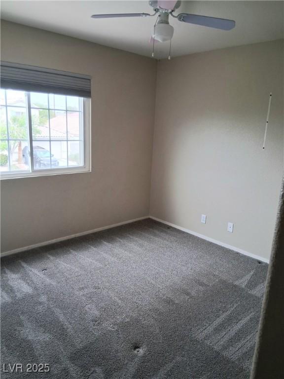5830 Springmist St, North Las Vegas, NV 89031 - empty room with carpet floors, a ceiling fan, and baseboards