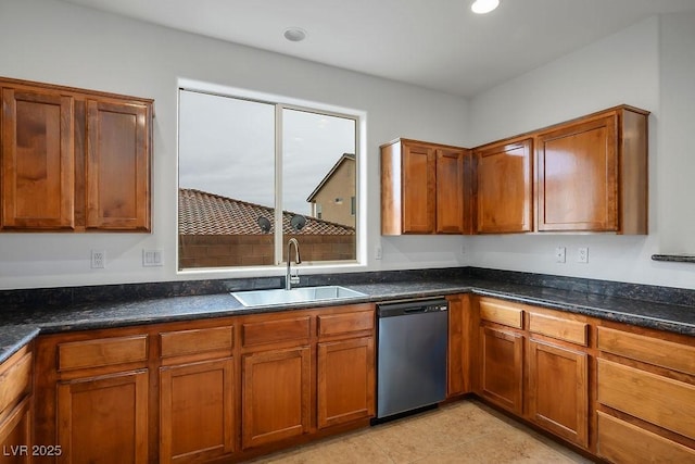 kitchen with dark stone countertops, sink, light tile patterned floors, and dishwasher