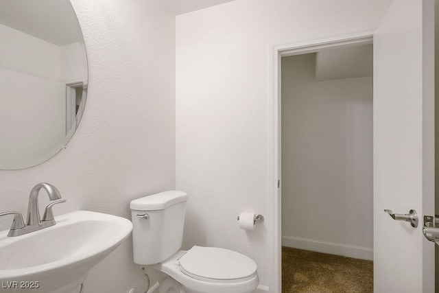 bathroom featuring toilet and sink