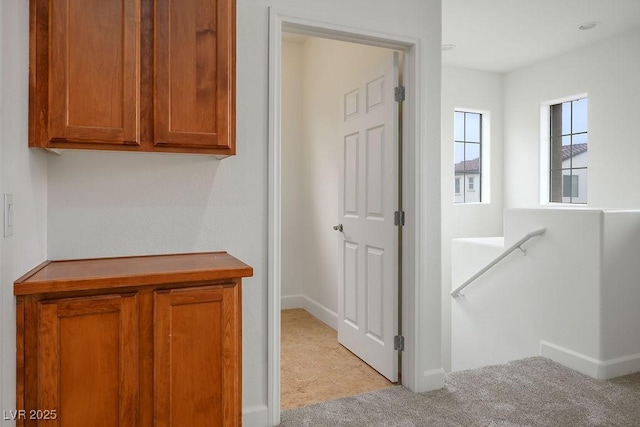 corridor with light colored carpet