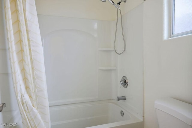 bathroom featuring toilet and shower / bath combo