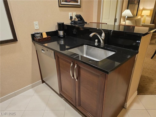 135 E Harmon Ave Unit 2120, Las Vegas, NV 89109 - kitchen with baseboards, white dishwasher, dark countertops, and a sink