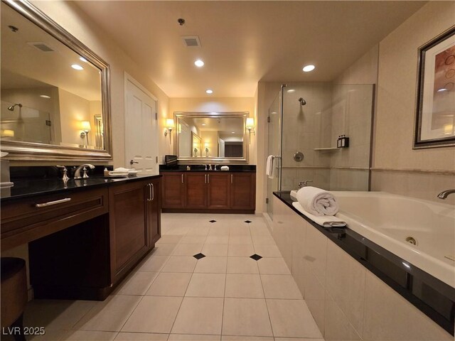 135 E Harmon Ave Unit 2120, Las Vegas, NV 89109 - bathroom featuring a tub with jets, tile patterned floors, a stall shower, and vanity