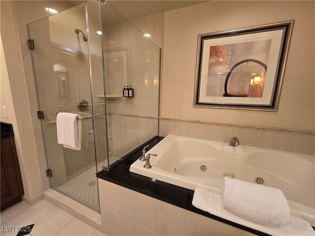 135 E Harmon Ave Unit 2120, Las Vegas, NV 89109 - full bathroom featuring a jetted tub, tile patterned flooring, and a shower stall