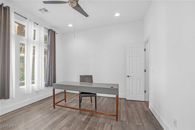 home office with hardwood / wood-style flooring and ceiling fan