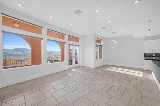 unfurnished living room featuring a mountain view