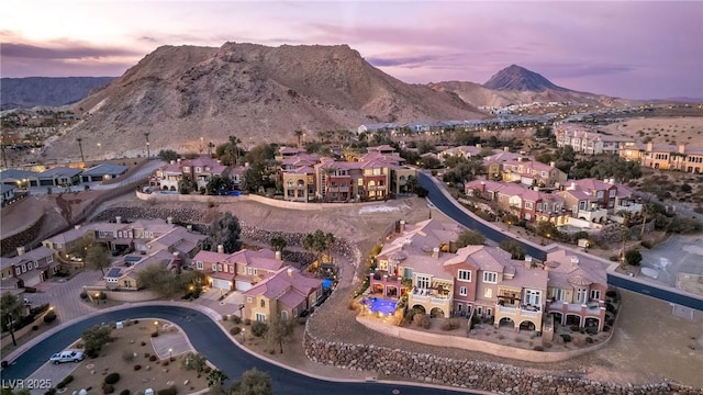 aerial view at dusk featuring a residential view and a mountain view