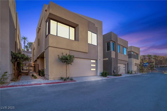 outdoor building at dusk with a garage