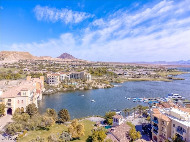 drone / aerial view with a water and mountain view