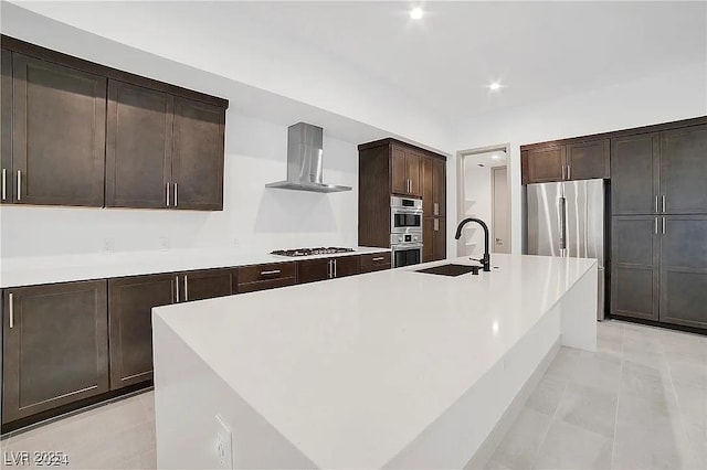 kitchen with island range hood, a kitchen island with sink, stainless steel appliances, light countertops, and a sink