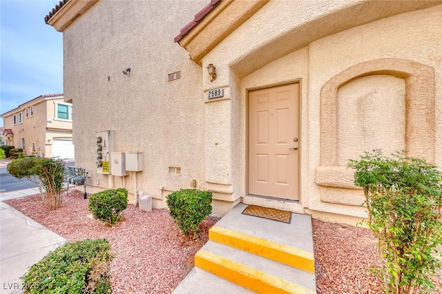 view of exterior entry with a garage