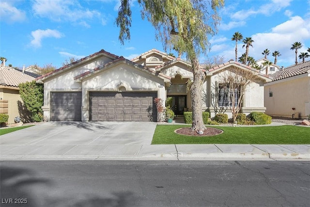 mediterranean / spanish house featuring a garage and a front lawn