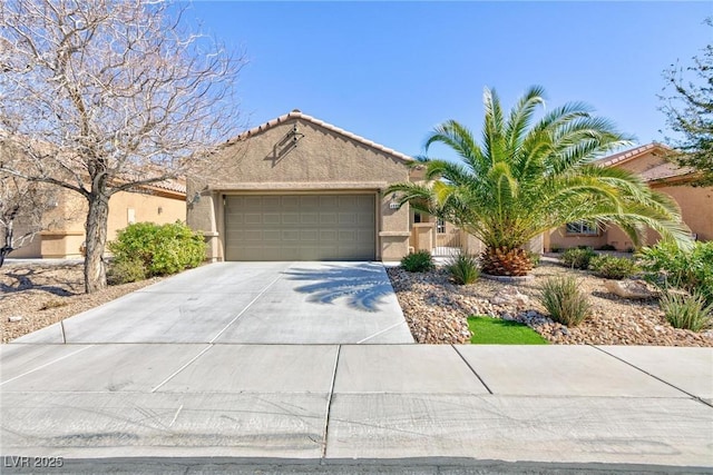 view of front of home featuring a garage, a tile roof, driveway, and stucco siding