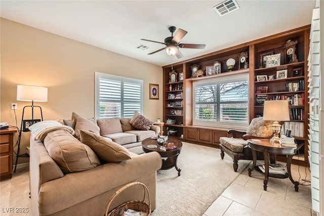 living room featuring light carpet and ceiling fan