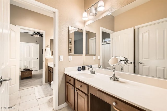 bathroom with ceiling fan, vanity, toilet, and tile patterned floors