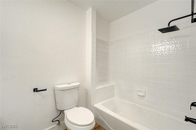 bathroom with shower / washtub combination and toilet