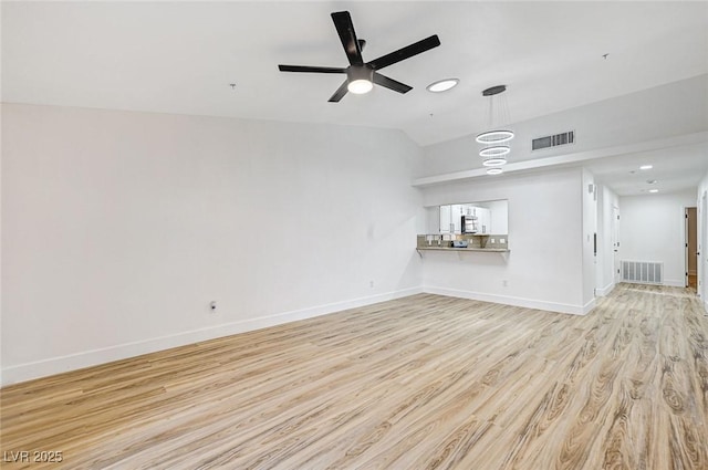 unfurnished living room with ceiling fan, lofted ceiling, and light hardwood / wood-style floors