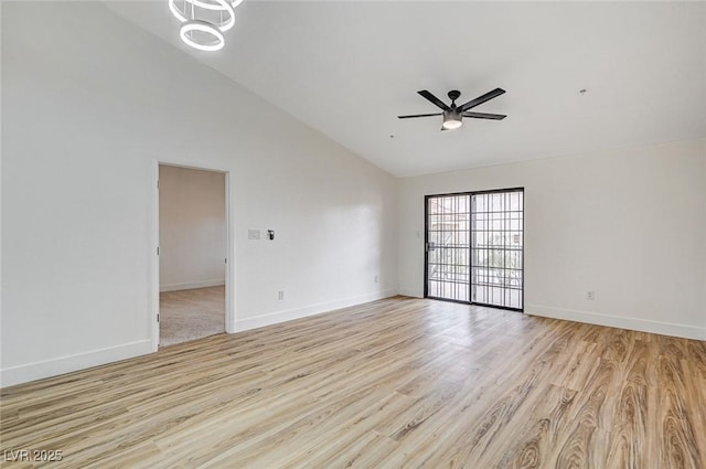 empty room with high vaulted ceiling, ceiling fan, and light wood-type flooring