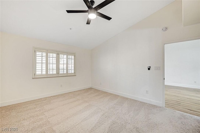 carpeted empty room with ceiling fan and lofted ceiling