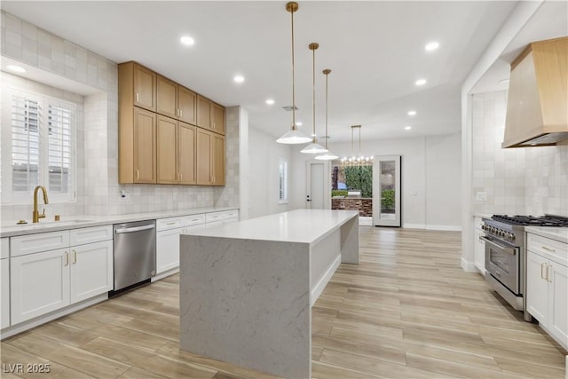 kitchen featuring stainless steel appliances, a kitchen island, sink, custom range hood, and white cabinets