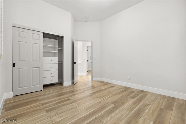 unfurnished bedroom featuring a closet and light hardwood / wood-style flooring