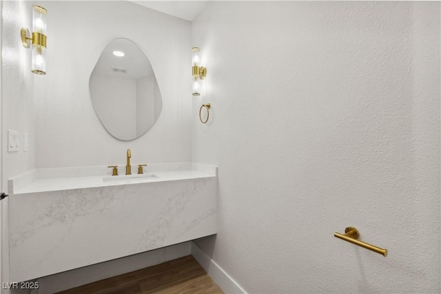 bathroom featuring hardwood / wood-style flooring and vanity