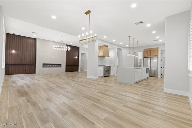 unfurnished living room featuring a fireplace and light hardwood / wood-style flooring